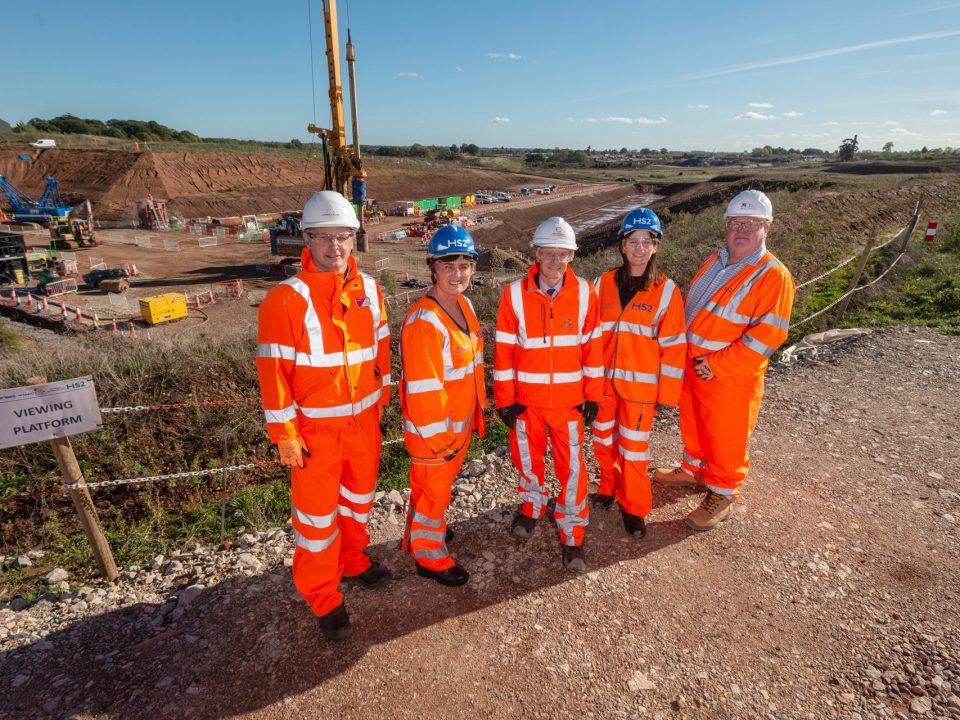 Arden Cross team in hi-vis outfits and hard hats in front of the development site.